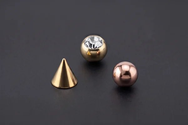 Gold gemstone ball, gold cone and rose-gold jewellery attachment