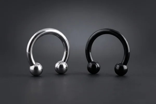 Silver and black horseshoe barbells with open gaps