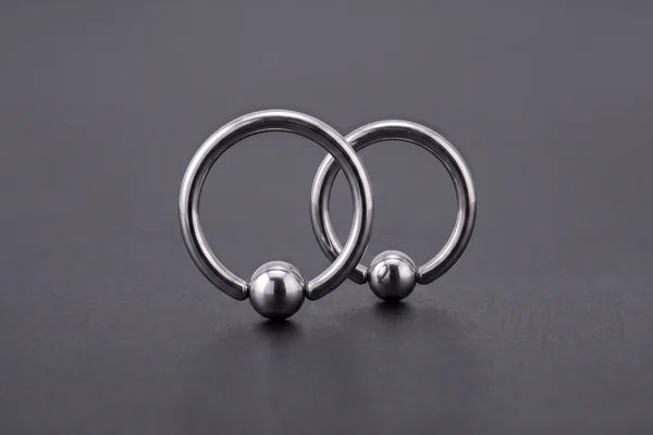 Two silver ball closure rings with captive beads